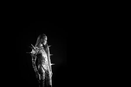 woman standing beside black wall thumbnail
