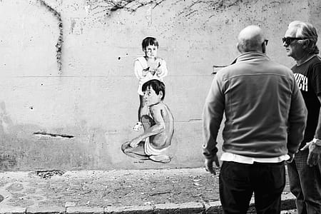 Two Man Standing Beside Concrete Wall thumbnail