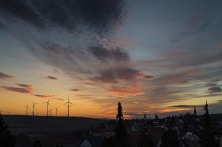 silhouette of windmills during golden hour thumbnail