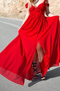 woman standing in the middle of the road during daytime thumbnail