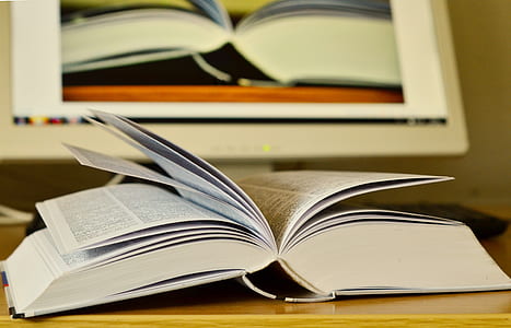 opened white book on table thumbnail