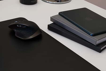 black cordless computer mouse beside the DVD case thumbnail