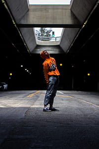 man standing looking upward on garage thumbnail