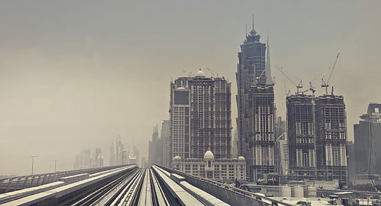 Sand Fog Engulfed Skyscrapers and Metro Train Track In Dubai thumbnail