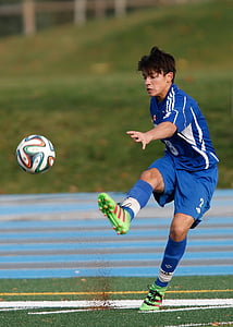 man wearing blue soccer jersey on green lawn grass thumbnail
