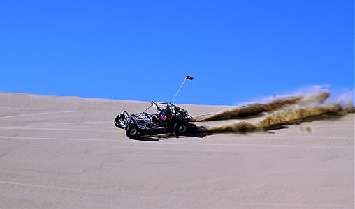 photography of black dune buggy near brown desert during daytime thumbnail