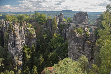 gray rock formations surrounded by trees thumbnail