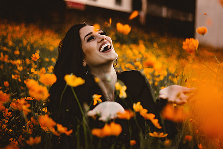 Laughing woman in flowers with smile thumbnail