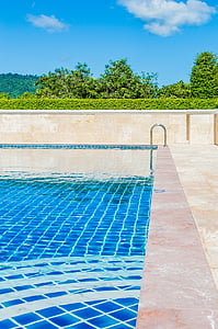 blue swimming pool under blue sky during daytime thumbnail