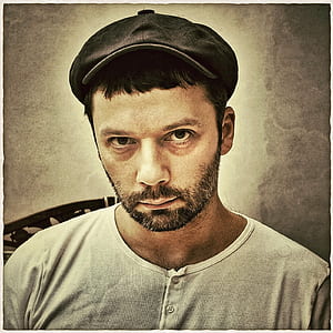 man wearing button-up top and gray cap painting thumbnail