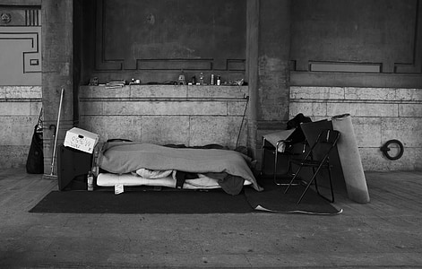 grayscale photo of bed on black area rug thumbnail
