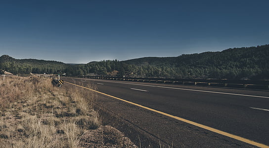 gray road under blue sky thumbnail