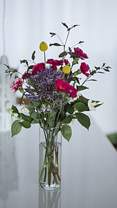 pink and yellow flowers in clear glass vase thumbnail