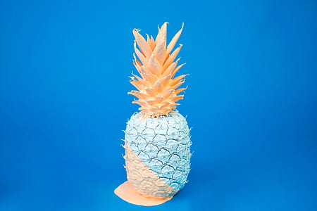 blue and orange pineapple against blue background thumbnail