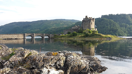 photograph of castle in the middle of lake at daytime thumbnail