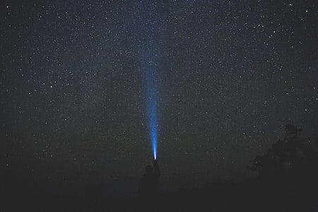 silhouette photography of person holding flashlight thumbnail