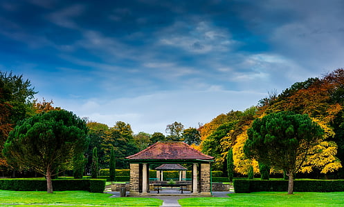 brown gazebo beside garden thumbnail