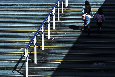 woman and girl walking up to staircase thumbnail