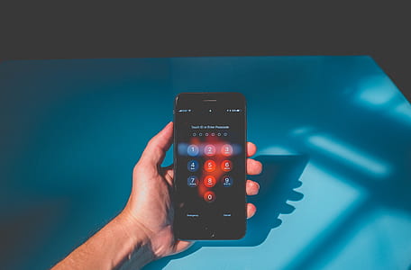 person holding a black iPhone thumbnail