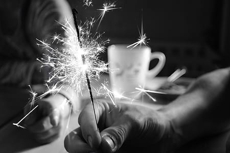 person holding firecrackers near mug thumbnail