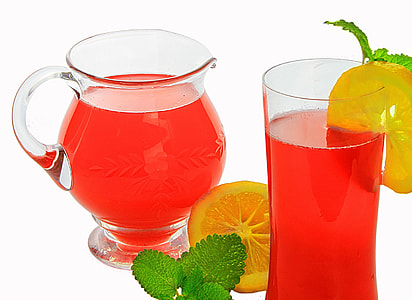 red juice in pitcher and glass with slice of lemon thumbnail