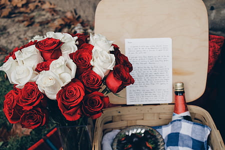 white and red roses near brown basket filled with red labeled bottle thumbnail
