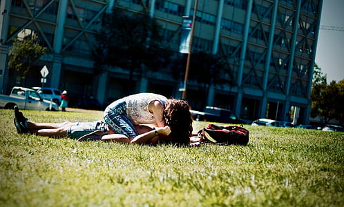 Man and Woman Lying on Green Field thumbnail