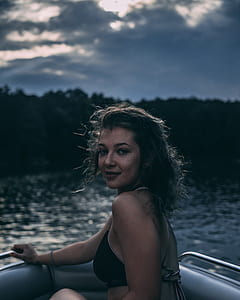 woman riding on gray boat during daytime thumbnail
