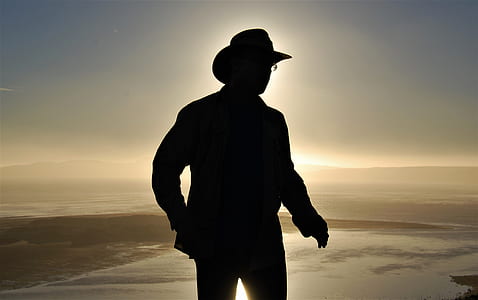 man standing on brown sand during daytime thumbnail