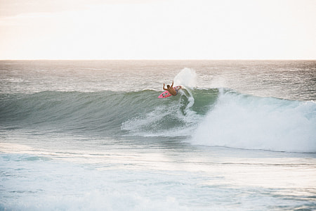 person surfing during daytime thumbnail