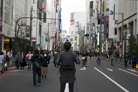 people walking on pedestrian lane under tall buildings thumbnail