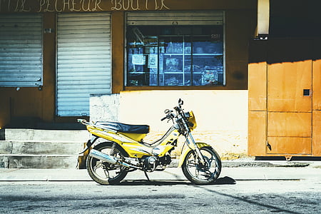 yellow underbone motorcycle parked outside store thumbnail