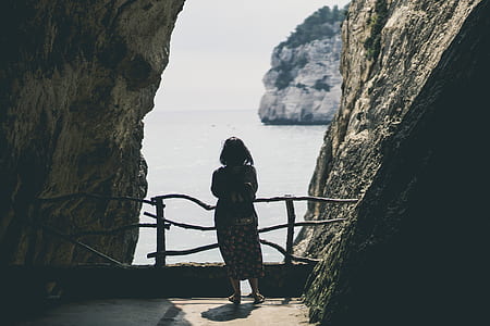 woman standing in the middle of stones thumbnail