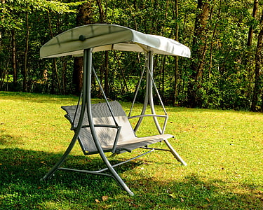 gray and white canopy bench swing near green trees thumbnail