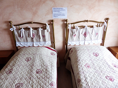 two beige bed inside room thumbnail