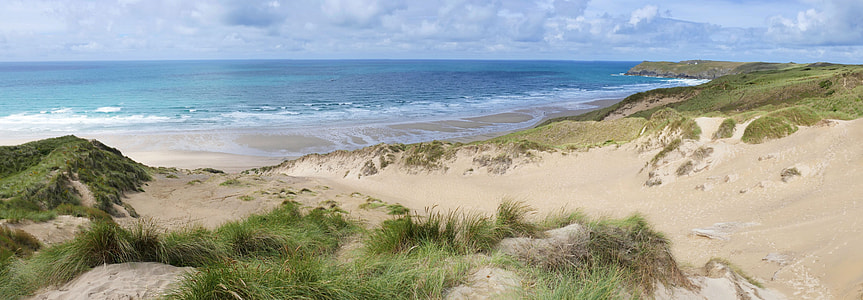 beach near the mountain under cumulus nimbus clouds thumbnail