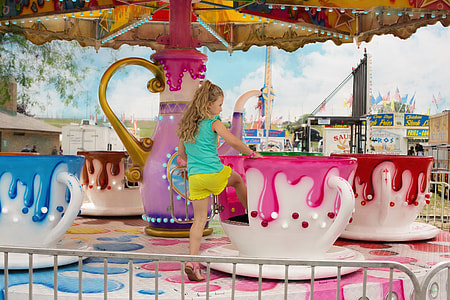 girl about to sits on teacup carousel thumbnail