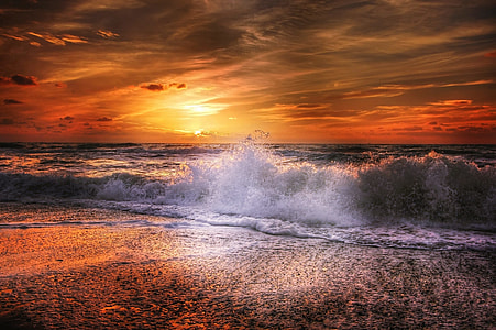 blue ocean waves on shore during sunset thumbnail