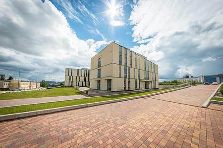 beige 3-storey building under cloudy sky thumbnail