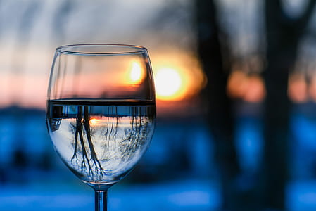 selective focus photography of clear wine glass during golden hour thumbnail