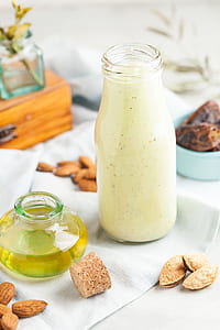 clear glass bottle with liquid beside a bottle filled with oil thumbnail