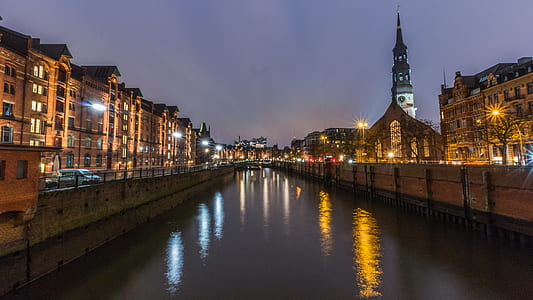 body of water in the middle of city during night thumbnail