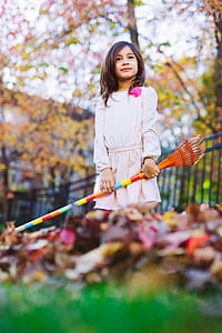 girl holding a rake selective focus photography thumbnail