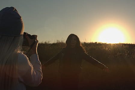Person Taking Photo of Another Person during Sunset thumbnail