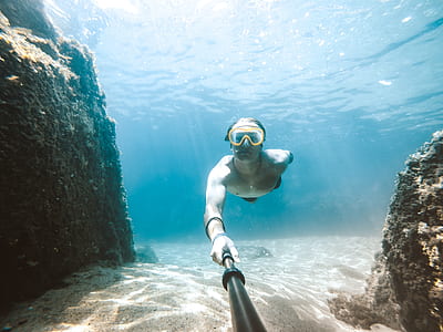 man swimming in body of water taking selfie thumbnail