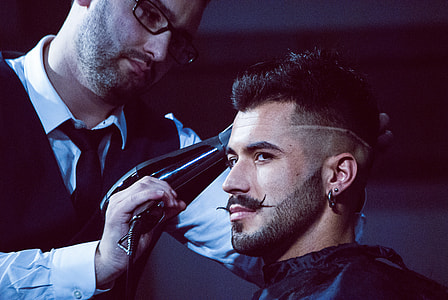 man holding electric razor beside man thumbnail