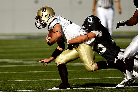 two men playing football on field thumbnail