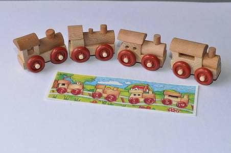 brown-and-red wooden toy train on white surface thumbnail