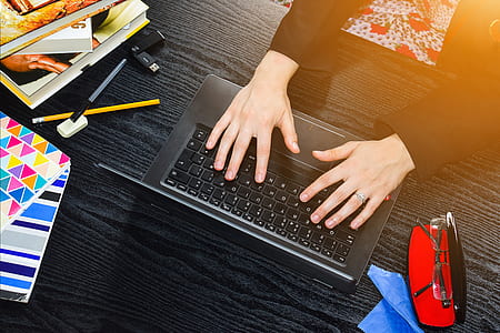 person holding black laptop computer thumbnail