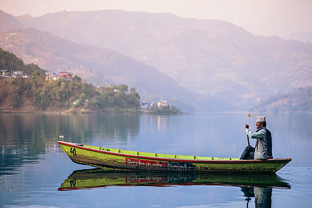 person rowing boat during daytime thumbnail